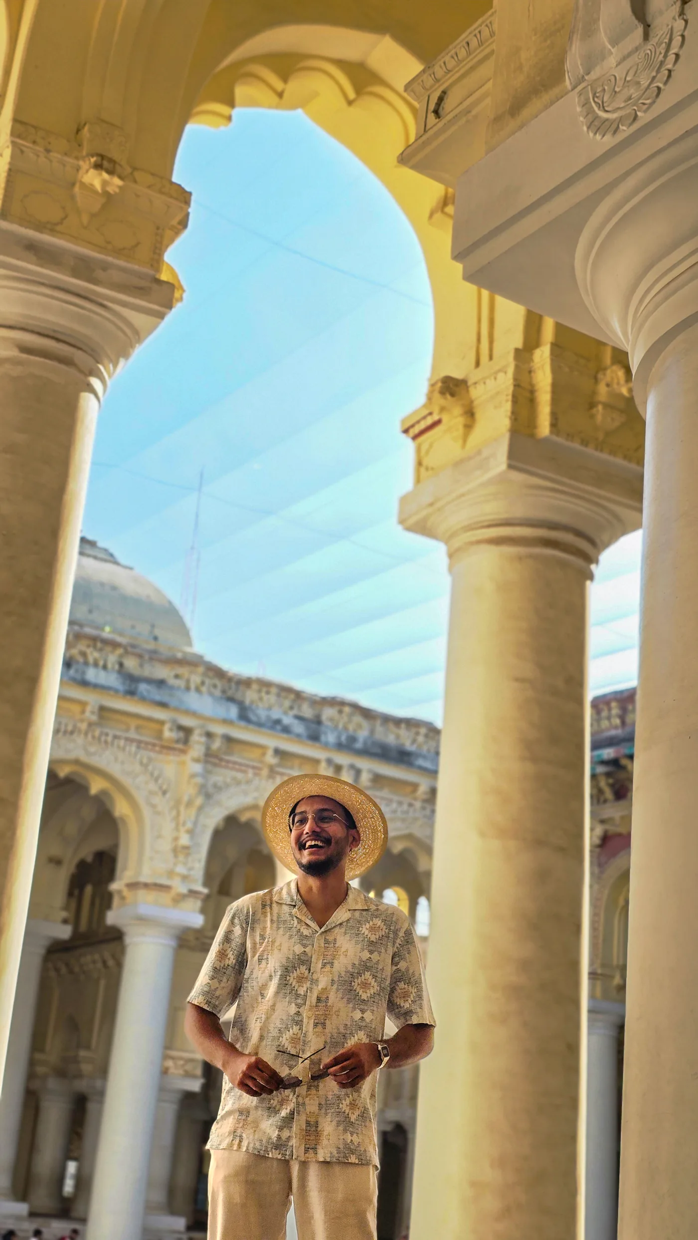Milind Gauns laughing beneath the arches of Thirumalai Nayakkar Mahal